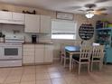 Bright kitchen with white cabinets, butcher block countertops, and a cozy dining area at 312 North Blvd W, Davenport, FL 33837
