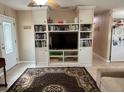Spacious living room featuring a large entertainment center with built-in shelving at 312 North Blvd W, Davenport, FL 33837