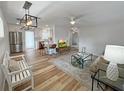 Inviting living room with hardwood floors and open concept to the kitchen and stylish modern decor at 412 Sunny Ct, Fruitland Park, FL 34731