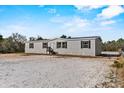 Well-maintained single-story house with gray siding and a simple landscape at 48 Oakridge Dr, Frostproof, FL 33843