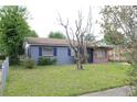 Charming single-story home features a brick and gray painted exterior and a well-maintained front lawn at 5177 Edwina St, Orlando, FL 32811