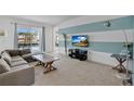 Cozy living room with sliding doors to pool area, stylish decor and plenty of natural light at 598 Marcello Blvd, Kissimmee, FL 34746