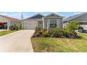 Charming single story home with blue and gray accents, attached garage, and well-kept landscaping at 6342 Whittle Ct, The Villages, FL 32163