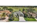 Aerial shot of a house with a well-kept yard near a golf course at 685 Winifred Way, The Villages, FL 32162