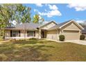 Well-kept single-story home featuring a manicured lawn and inviting exterior at 814 Olive Ave, Fruitland Park, FL 34731