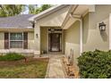 Inviting home entrance with a stone walkway, well-kept landscaping, and decorative lighting at 814 Olive Ave, Fruitland Park, FL 34731