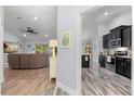 Open concept living space with hardwood floors leading to a modern kitchen at 814 Olive Ave, Fruitland Park, FL 34731
