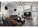 Spacious living room featuring tile flooring, modern ceiling fan and comfortable leather couches at 831 Whisper Sound, Minneola, FL 34715