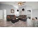 Bright living room with tile floors, ceiling fan, two leather sofas, and decorative accents at 831 Whisper Sound, Minneola, FL 34715