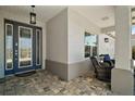 Welcoming entryway with covered porch, decorative glass door, and comfortable seating at 8433 Sw 98Th Terrace Rd, Ocala, FL 34481