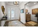 Bright foyer with decorative glass door, wood floors, and elegant console table at 8433 Sw 98Th Terrace Rd, Ocala, FL 34481