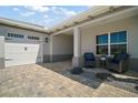 Attached two-car garage and covered patio with comfortable seating for relaxing outdoors at 8433 Sw 98Th Terrace Rd, Ocala, FL 34481