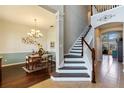 Grand entryway with staircase, hardwood floors, and view of dining area with chandelier at 1001 Harmony Ln, Clermont, FL 34711