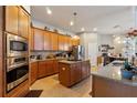 Spacious kitchen with stainless steel appliances, granite countertops, and ample wood cabinetry at 1001 Harmony Ln, Clermont, FL 34711