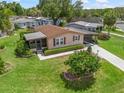 Well-maintained single-story home with manicured landscaping and inviting screened-in porch in a desirable neighborhood at 1003 Parker Pl, Lady Lake, FL 32159
