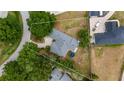 Aerial view of property highlighting the home, mature trees, and lawn, surrounded by a white boundary line at 11024 Windchime Cir, Clermont, FL 34711