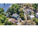 An aerial view that shows a home nestled among lush trees near the community waterfront at 12110 Palmetto Ct, Dunnellon, FL 34432