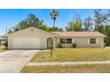 Lovely single-story home featuring an attached garage and well-maintained front lawn and inviting curb appeal at 1415 S Baton Dr, Deltona, FL 32725