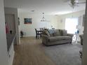 Bright living room with modern furniture, wood floors and open dining area at 1420 Fairway St, The Villages, FL 32162