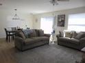 Inviting living room with comfortable seating and an adjacent dining area at 1420 Fairway St, The Villages, FL 32162