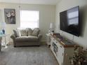 Cozy living room with modern entertainment center and comfortable seating at 1420 Fairway St, The Villages, FL 32162
