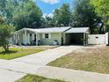 Lovely one-story home featuring a covered carport, well-kept lawn, and inviting front entrance at 14536 Sw 34Th Terrace Rd, Ocala, FL 34473