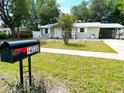 Quaint one-story home with a well-maintained lawn, covered carport, and welcoming front entrance at 14536 Sw 34Th Terrace Rd, Ocala, FL 34473