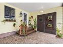 Inviting covered entryway showcasing plants, brick accents, and double doors at 1639 W Schwartz Blvd, The Villages, FL 32159