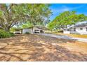 Exterior view of a property showing garage, carport, and ample parking space on the long driveway at 16724 Highland Ave, Montverde, FL 34756