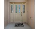 Elegant front door with decorative glass and side lites at 1741 Pennecamp Dr, The Villages, FL 32162