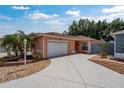 Charming single-story home featuring a well-maintained lawn, attached garage, and inviting curb appeal at 1814 Marquez Loop, The Villages, FL 32159