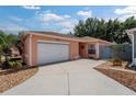 Charming single-story home featuring a well-maintained lawn, attached garage, and inviting curb appeal at 1814 Marquez Loop, The Villages, FL 32159