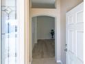 Inviting entryway features an arched doorway and wood-look flooring at 1954 Ladyfish Ave, The Villages, FL 32162