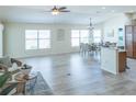 Spacious living room with vaulted ceilings, lots of natural light and wood-look floors at 1954 Ladyfish Ave, The Villages, FL 32162