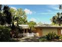Charming single Gathering home with a white picket fence and lush landscaping and an attached garage at 2121 Suzanne Dr, Mount Dora, FL 32757