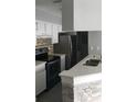 Modern kitchen with stainless steel appliances, white cabinetry, and a stylish backsplash at 234 Afton Sq # 205, Altamonte Springs, FL 32714