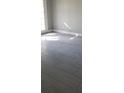 Bright room features modern gray tile flooring and a sliding glass door providing ample natural light at 234 Afton Sq # 205, Altamonte Springs, FL 32714