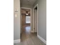 Hallway featuring ceramic tile floors leading into a bedroom with ceiling fan and window at 234 Afton Sq # 305, Altamonte Springs, FL 32714