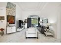 Bright living room boasts high ceilings, modern decor, and access to the screened patio at 2497 Heritage Green Ave, Davenport, FL 33837