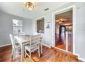 Dining room with wooden table and chairs, and an open view into the living room and kitchen at 26619 Bimini Dr, Tavares, FL 32778