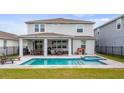 Inviting backyard featuring a covered patio, swimming pool, and spa, perfect for outdoor entertaining at 3235 Buoy Cir, Winter Garden, FL 34787