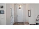 Bright foyer with wood-look tile, stylish lighting and white doors leading to another room at 3235 Buoy Cir, Winter Garden, FL 34787