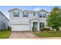 Beautiful two-story home featuring light blue siding, blue shutters, and brick paver driveway at 3235 Buoy Cir, Winter Garden, FL 34787
