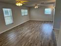 Spacious living room featuring wood-look flooring, ceiling fans, and natural light at 32737 Vista Ave, Leesburg, FL 34788