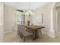 Formal dining area with chandelier lighting, neutral tones, and large windows at 33222 Irongate Dr, Leesburg, FL 34788
