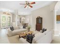 Bright living room featuring neutral colors, tile flooring, and elegant furnishings at 33222 Irongate Dr, Leesburg, FL 34788