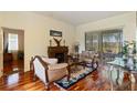 Living room boasts wood floors, fireplace, and sliding door to the outdoor patio at 3440 Tumbling River Dr, Clermont, FL 34711