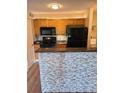 Kitchen with stainless appliances, tile backsplash, and breakfast bar counter at 420 Forestway Cir # 206, Altamonte Springs, FL 32701