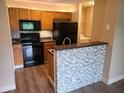Well-lit kitchen with stainless appliances, backsplash, and breakfast bar at 420 Forestway Cir # 206, Altamonte Springs, FL 32701