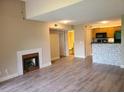 Open living area with a fireplace, wood-look floors, and access to the kitchen and bathroom at 420 Forestway Cir # 206, Altamonte Springs, FL 32701